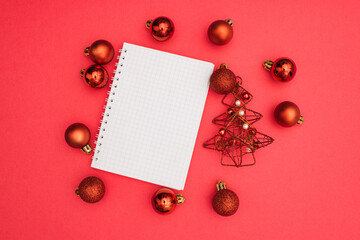 Naklejka na ściany i meble Christmas A5 notebook wire binding mock up blank template design idea. Red decorative balls, red Christmas tree, christmas decoration mockup against pastel pink background. Noel copy space.
