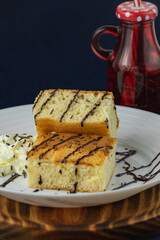 Lemon cake with cream, colored sugar flakes and chocolate syrup