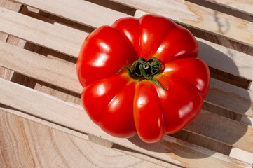 red tomato on wooden table