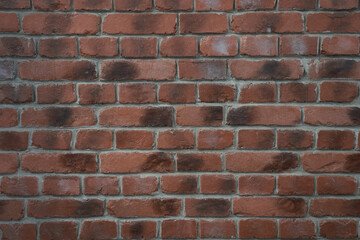 An old brick wall with weather spots.Red brick wall texture grunge background for interior design....