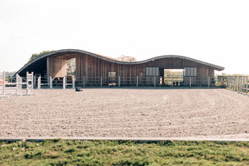design stables in a horse education center - modern horse farm with wooden and steel structures -...