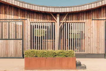 design stables in a horse education center - modern horse farm with wooden and steel structures -...