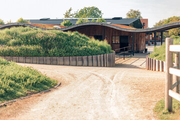 design stables in a horse education center - modern horse farm with wooden and steel structures -...