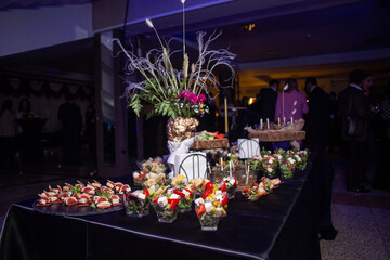 Snacks in plastic cups on the buffet at the event