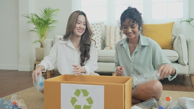 Nature conservation concept of 4k Resolution. Asian women collecting garbage together in the house. Roommates are doing activities in harmony.
