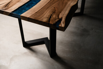 large table made of natural wood and epoxy resin on metal legs side view