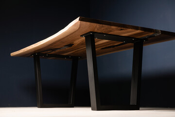 large table made of natural wood and epoxy on metal legs in the interior
