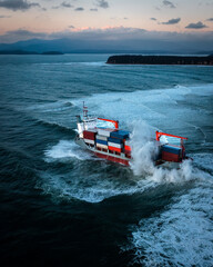 Container ship on stormy sea delivering cargo