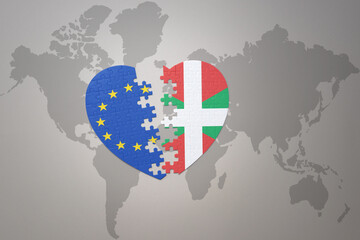 puzzle heart with the national flag of european union and basque country on a world map background. Concept.