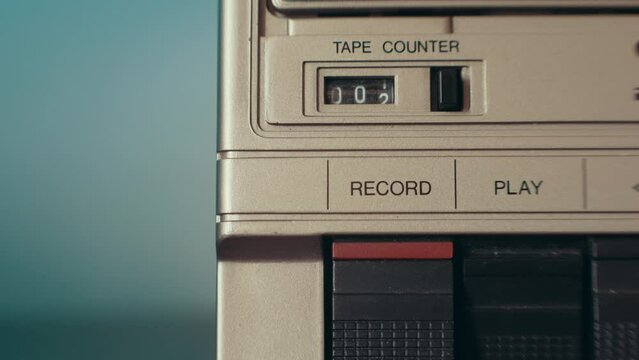 Tape recorder playing back music. Person confessing on a vintage tape recorder. Cassette slowly zooming in, plus rewinding and fast forwarding