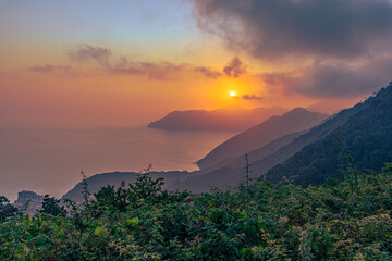 Sunset over of Cinque Terre on a hiking trail between the towns of Manarola and Corniglia, Italy