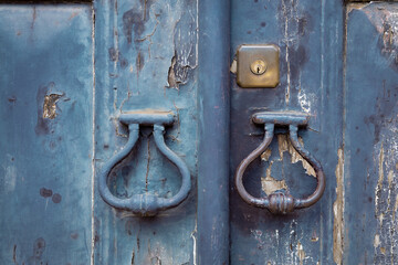 Close up of a lock on an old blue painted wooden door.