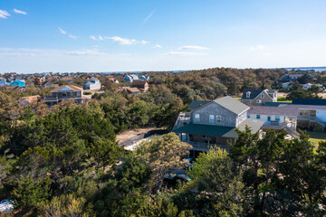 Aerial view of beach homes surrounded by maritime forest in the outer banks