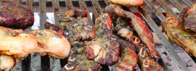 meat cooked on the grill over with Chops Ribs and pork sausages