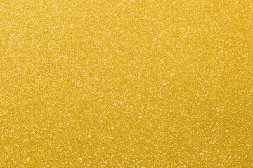 glitter background with bright golden color highlights usable as a backdrop for luxury concepts...