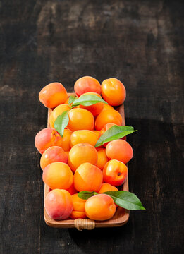 apricots in wooden bowl on wooden background © Vaceslav Romanov