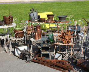 chairs coffee tables copper containers other rare pieces of vintage furniture in the antiques stall...