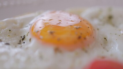 Healthy breakfast plate with fried eggs, tomatoes, cucumber and avocado on table. Closeup view