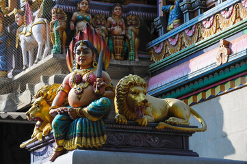 Goddess with a knife and twolions on the facade of a Hindu temple in Bangalore, Karnataka, India,...