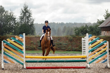 Beautiful lady jumping with her stud horse.