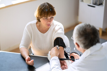 Young Doctor Checking Blood Pressure