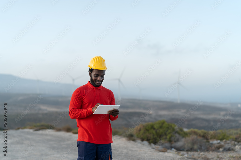 Wall mural African engineer working with tablet on construction site - Technology and industry concept