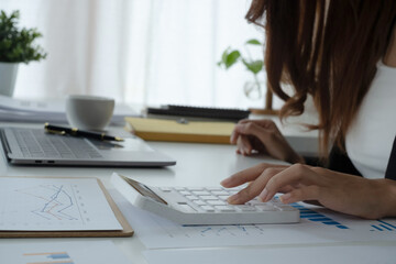 Woman calculate domestic bills at home. Businesswoman using calc