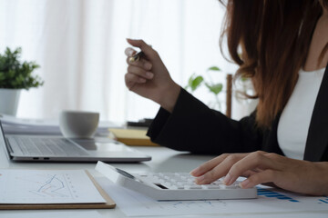 Woman calculate domestic bills at home. Businesswoman using calc