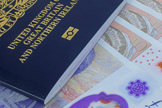 UK biometric passport and Sterling money.