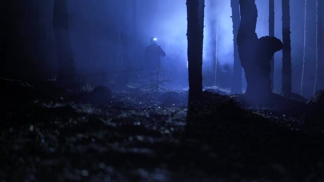 Man walking with pickaxe. Foggy forest night.
Man walking in night foggy forest with pickaxe hand. Full of fear.

