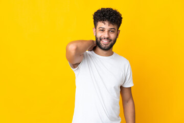 Young Moroccan man isolated on yellow background laughing