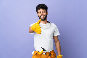 Young electrician Moroccan man isolated on purple background shaking hands for closing a good deal