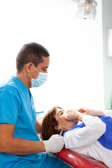 Orthodontic specialist dentist treating an adult female patient