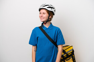 Young English woman with thermal backpack isolated on white background looking to the side and smiling