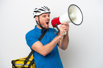 Young brazilian man with thermal backpack isolated on white background shouting through a megaphone