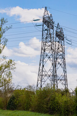 Observation of a power station and its large metal antennas, on a cloudy day, in the countryside