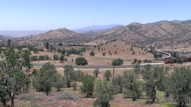 The Tehachapi Loop where Trains Cross over themelves to Climb a Steep Grade with 2 Trains Crossing together Time Lapse