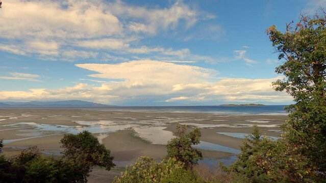 Vancouver Island Beach Tide and Clouds Timelapse 4K UHD. Time lapse clouds and tide on the Salish Sea. Georgia Strait, Parksville, British Columbia. 4K, UHD.
