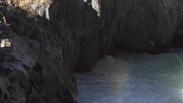 Rapid flow of a mountain river in a rocky gorge in the mountains