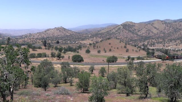 The Tehachapi Loop where Trains Cross over themelves to Climb a Steep Grade with 2 Trains Crossing together Time Lapse