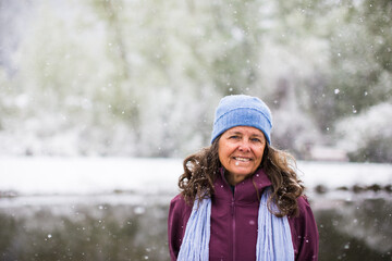 A portrait of a smiling middle aged woman on a cold and snowy day in Colorado, USA