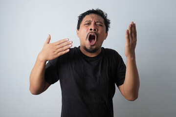 funny expression of overheated man while waving his hands