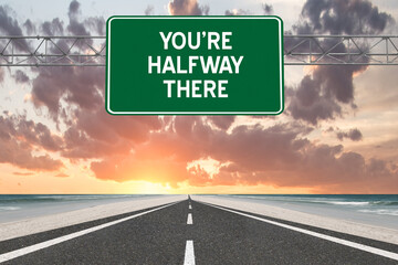 You're Halfway There motivational highway sign.