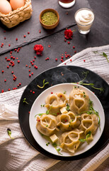 traditional Eastern dish manti or manty with beef in a dark