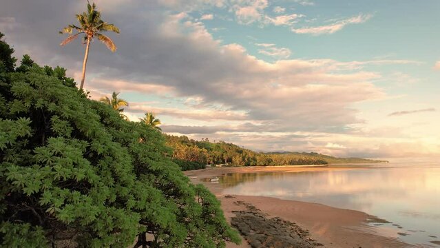 Fiji aerial footage warm sunset over sandy beach tropical paradise at Maui Bay