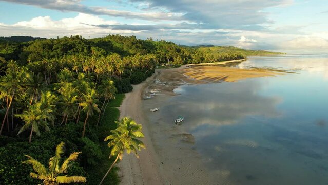 Fiji aerial footage warm sunset over sandy beach tropical paradise at Maui Bay