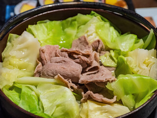 Close up shot of steamed pork with cabbage