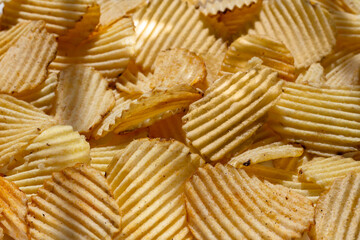 background corrugated golden chips with texture. selective focus, daylight