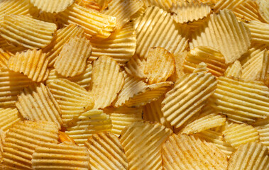 close-up background corrugated golden chips with texture. selective focus, daylight, view from above