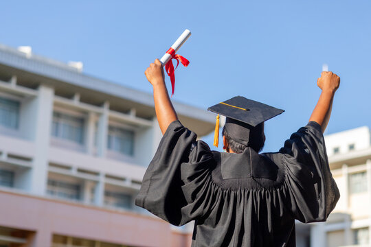 Graduates in gowns and graduation caps with diplomas